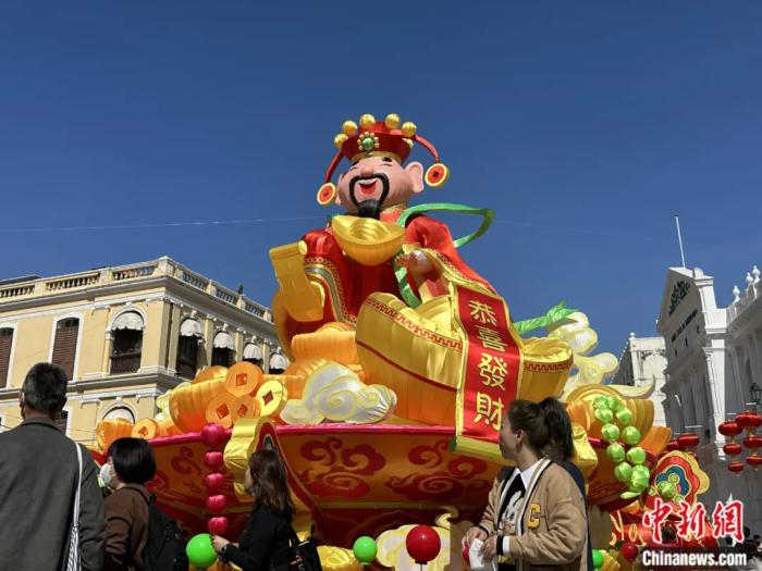 2023年春节期间,在澳门市中心议事亭前地广场中央,大型财神装饰吸引了许多游客。中新社记者 李亚南 摄